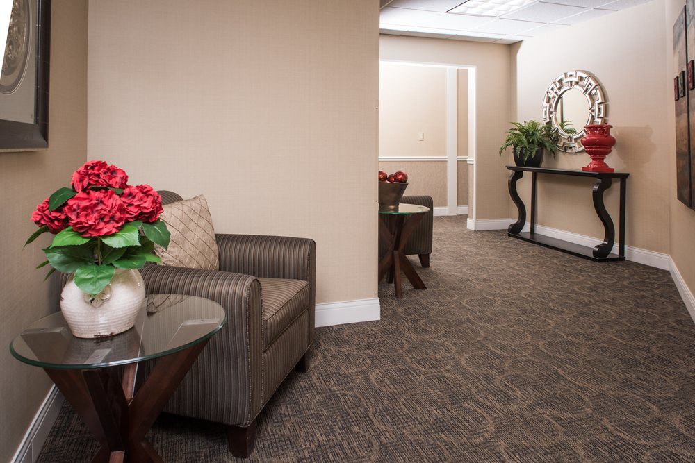 A modern office waiting area with comfortable seating and decor.