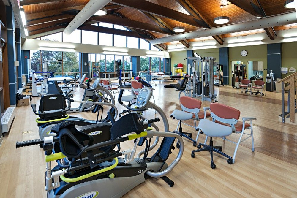 A spacious gym featuring various exercise machines and cardio equipment.