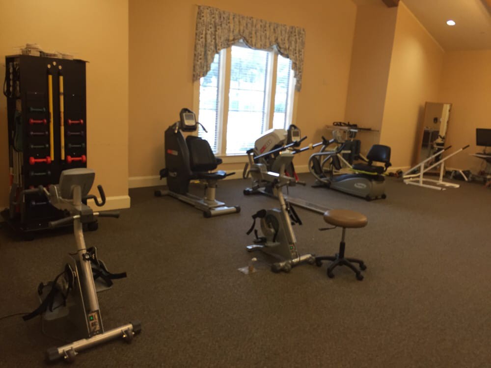 A quiet gym with exercise equipment and cycling machines.
