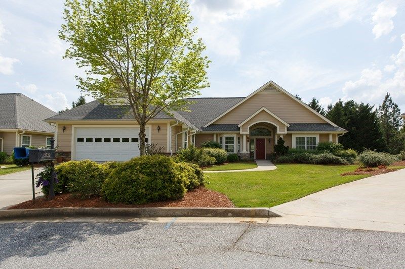 A suburban house with a well-maintained lawn and attached garage.