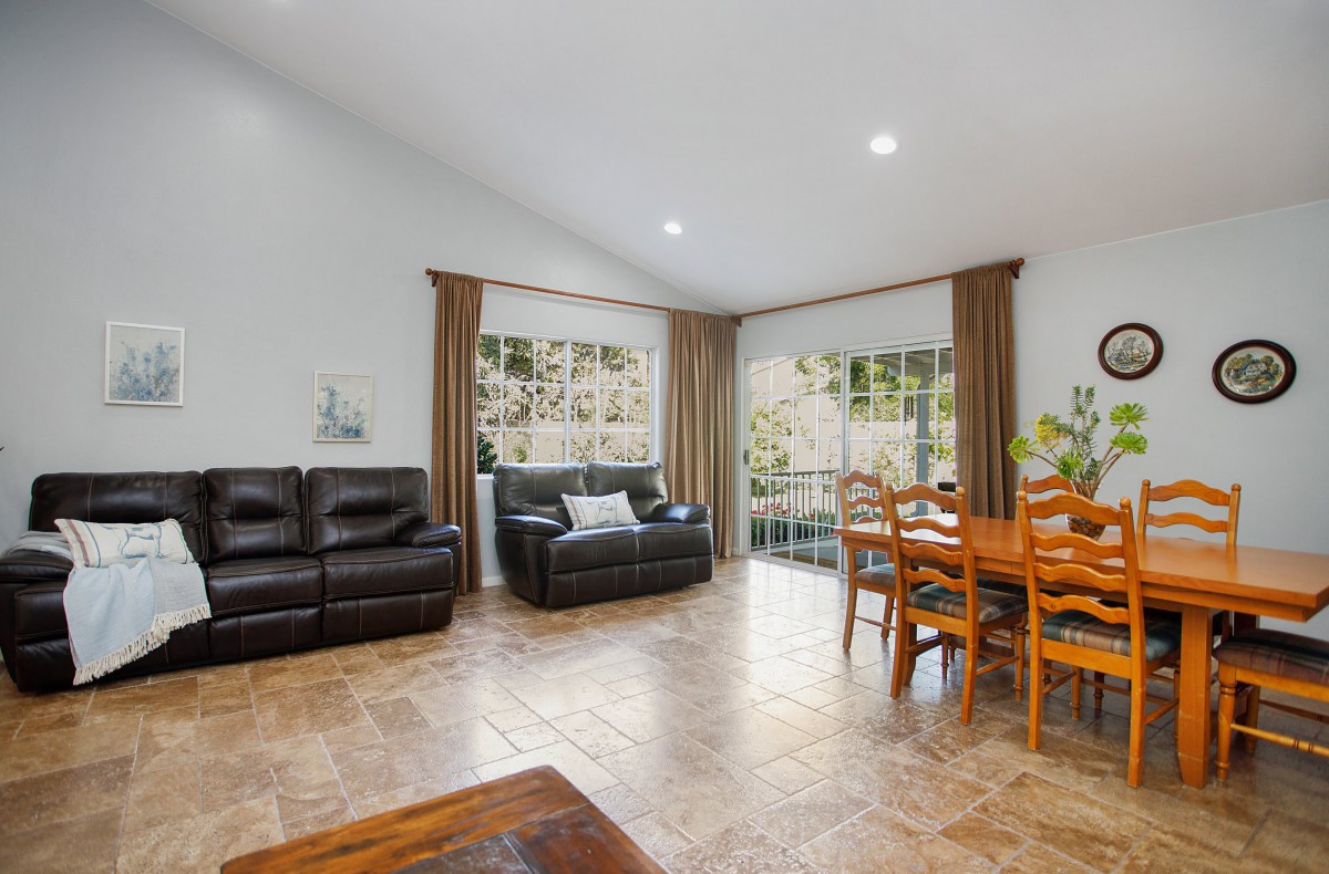 Spacious living and dining area with modern furniture and large windows.