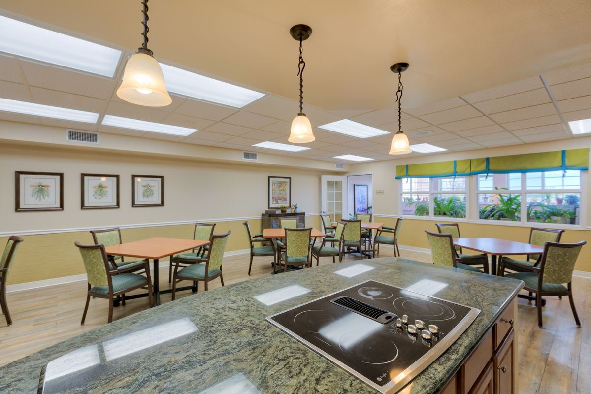 A modern indoor kitchen and dining area with stylish lighting and seating.