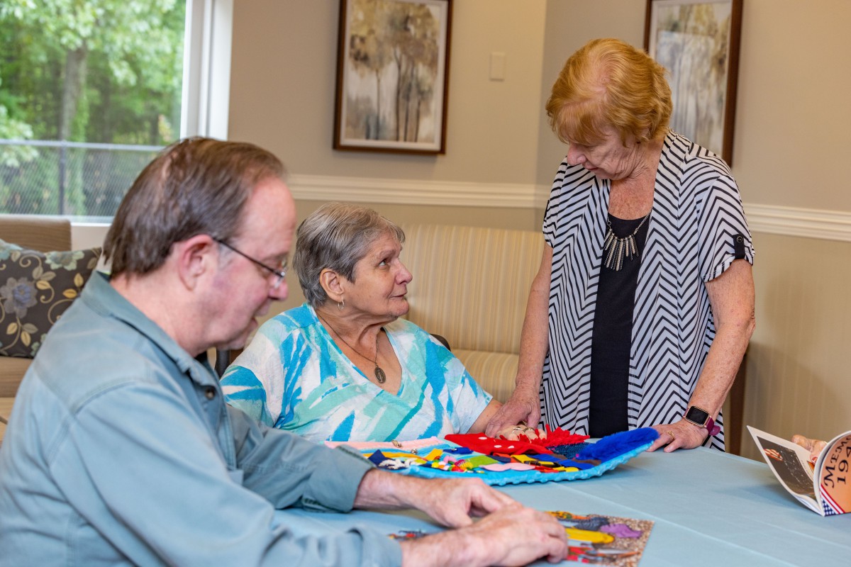 Elderly individuals engaging in a group activity in a care home setting.