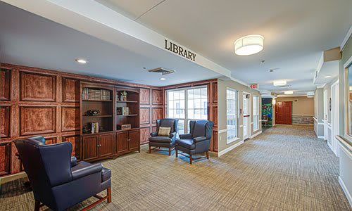 Cozy library interior with bookshelves and comfortable seating.