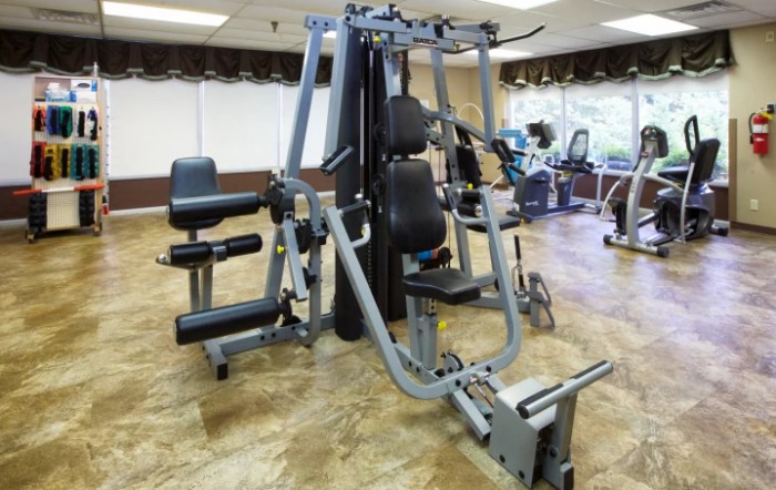 A multi-station gym machine in a fitness center.