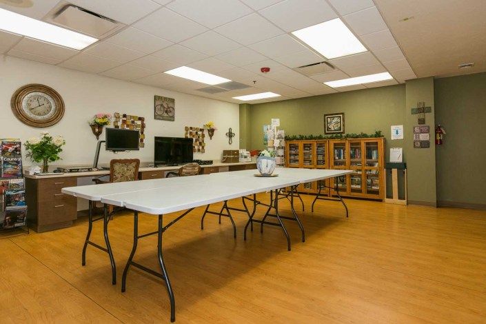 An indoor meeting room with a large conference table, several chairs, and decorative elements.