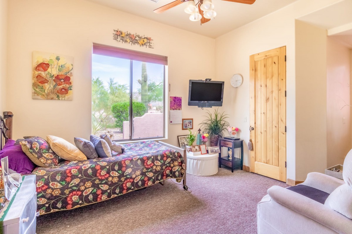 A cozy bedroom with a floral daybed and modern decor.