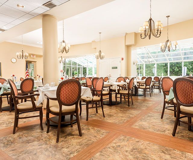 Elegant restaurant dining area with large windows and ornate chandeliers.