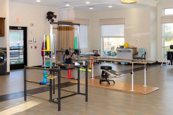 This image shows a rehabilitation center equipped with various exercise tools and equipment for physical therapy.