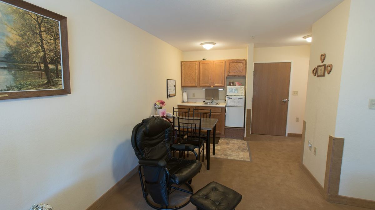 Cozy apartment with a small kitchenette and dining area.
