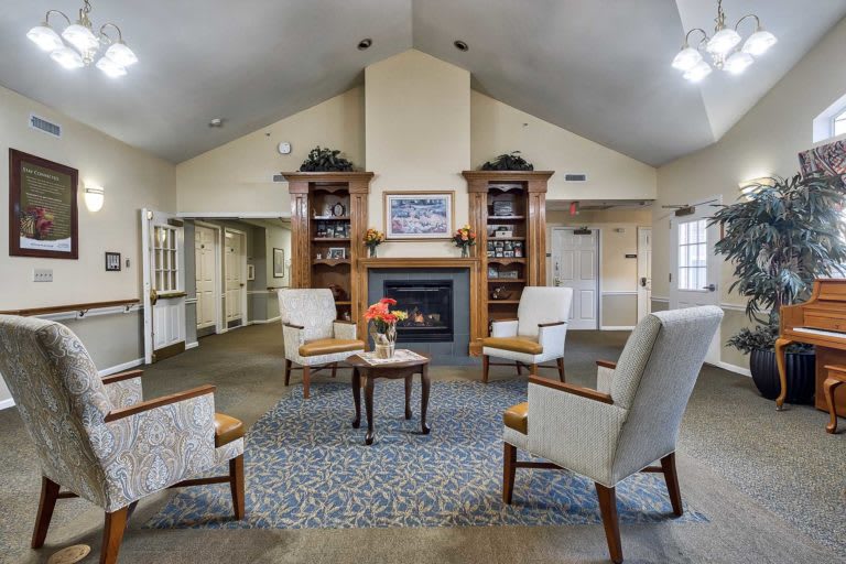 A cozy living room with a central fireplace and comfortable seating.