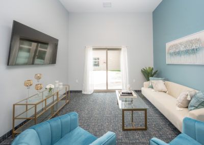 A modern living room with blue accents and sleek furniture.