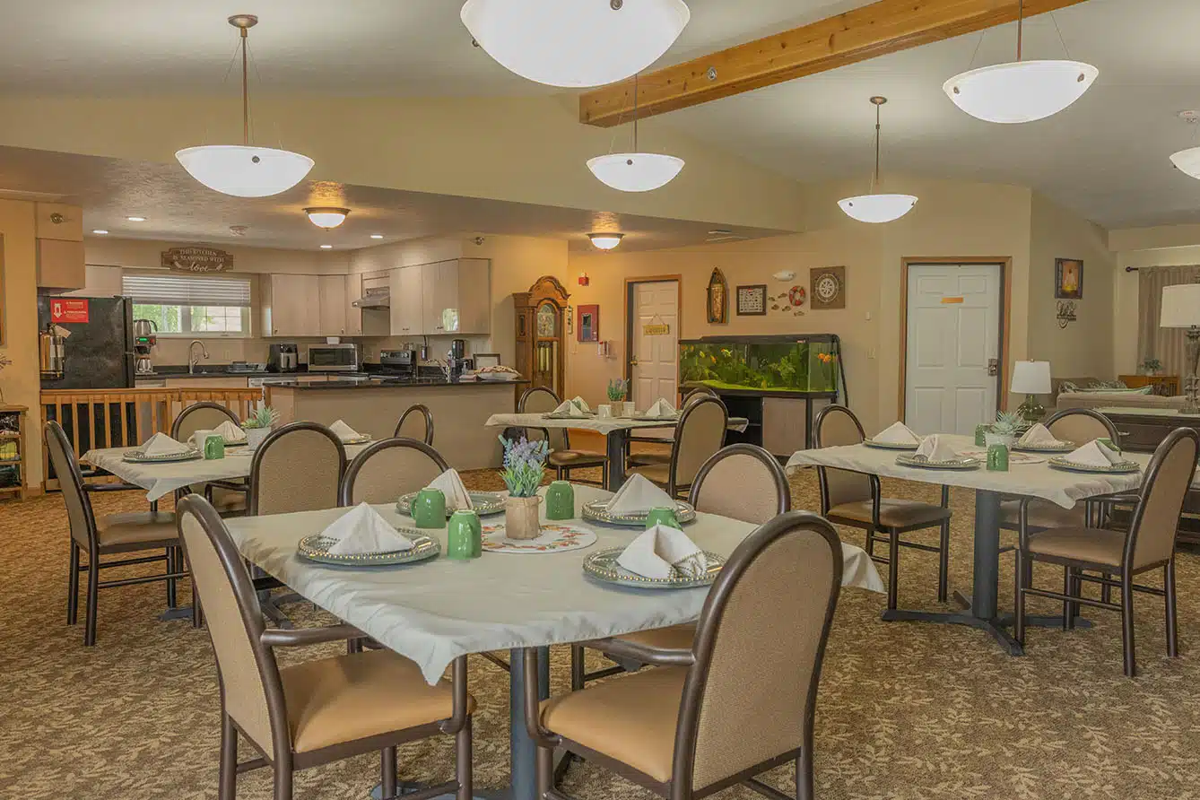 A cozy dining area with neatly set tables and comfortable lighting.