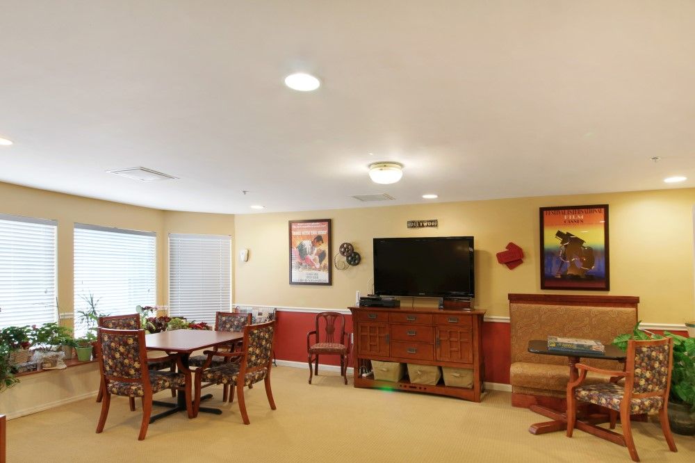 A cozy living room with a dining area, television, and stylish decor.