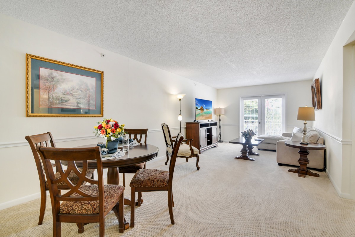 A spacious living and dining area with elegant furnishings and decor.