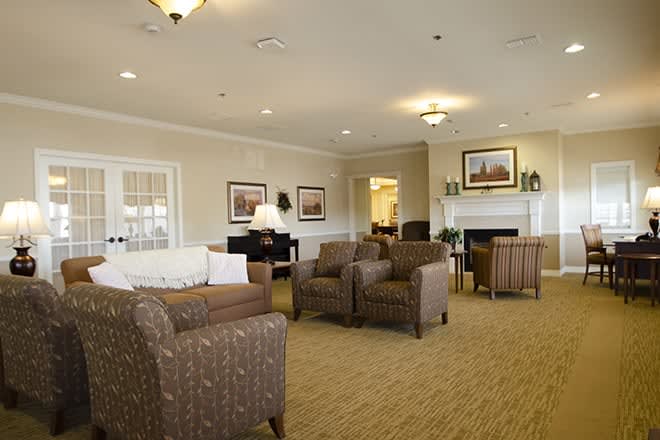 A cozy and elegantly designed living room with comfortable seating and warm lighting.