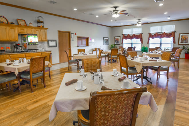 A cozy dining room setup with neatly arranged tables and chairs.