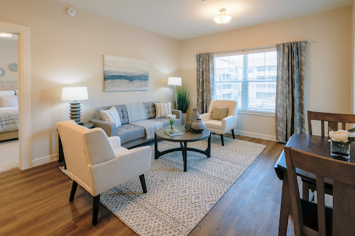 A beautifully designed modern living room featuring comfortable seating and ample natural light.