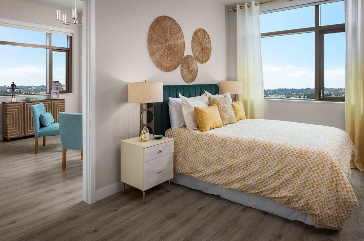 A cozy bedroom with elegant decor and a view through the window.