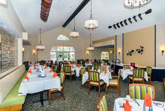 A well-decorated dining area with neatly arranged tables and chairs.