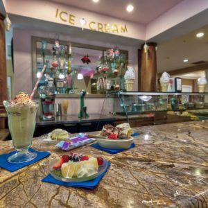 A cozy ice cream parlor with delicious desserts displayed on the counter.