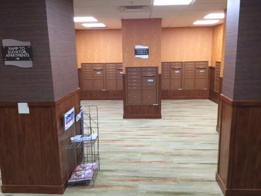 A view of a mailroom featuring wooden mailboxes and a clean, organized layout.