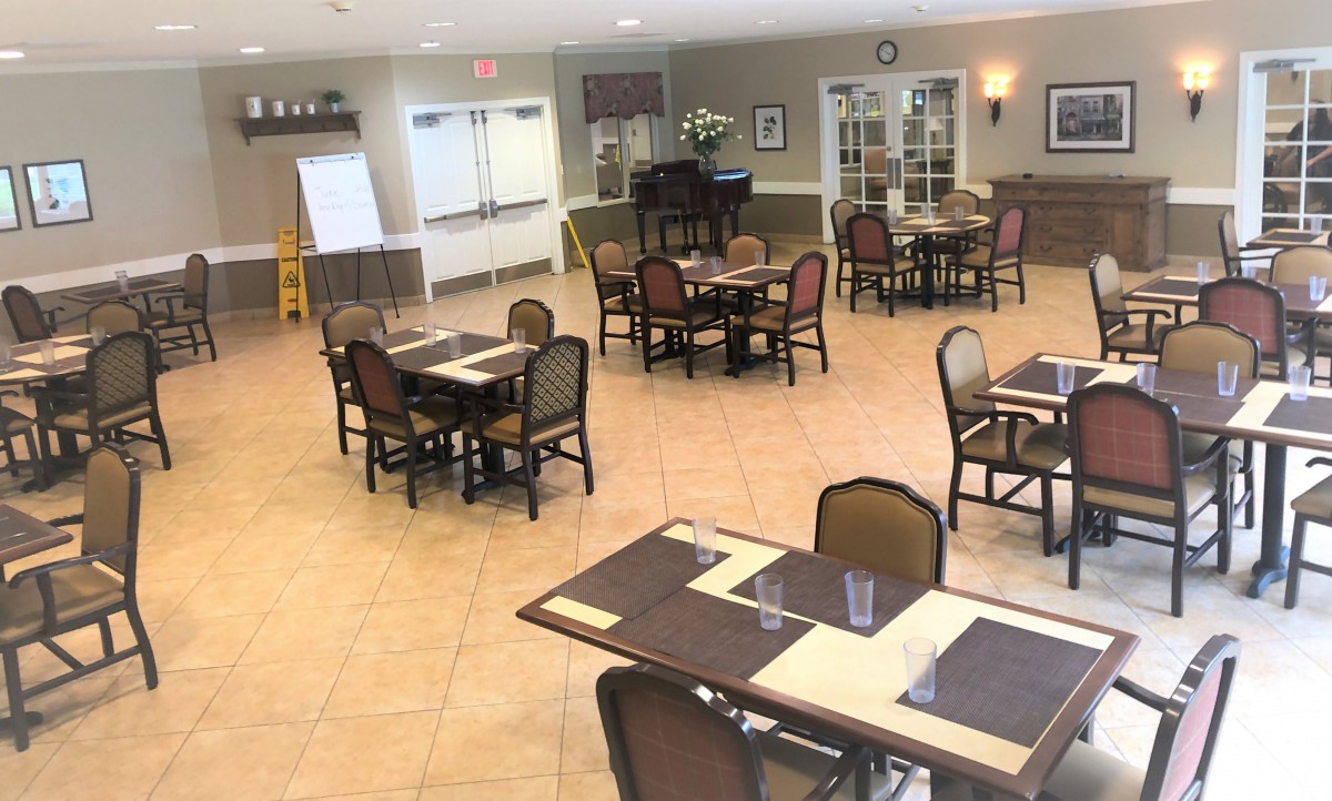 An empty dining area with neatly arranged tables and chairs.
