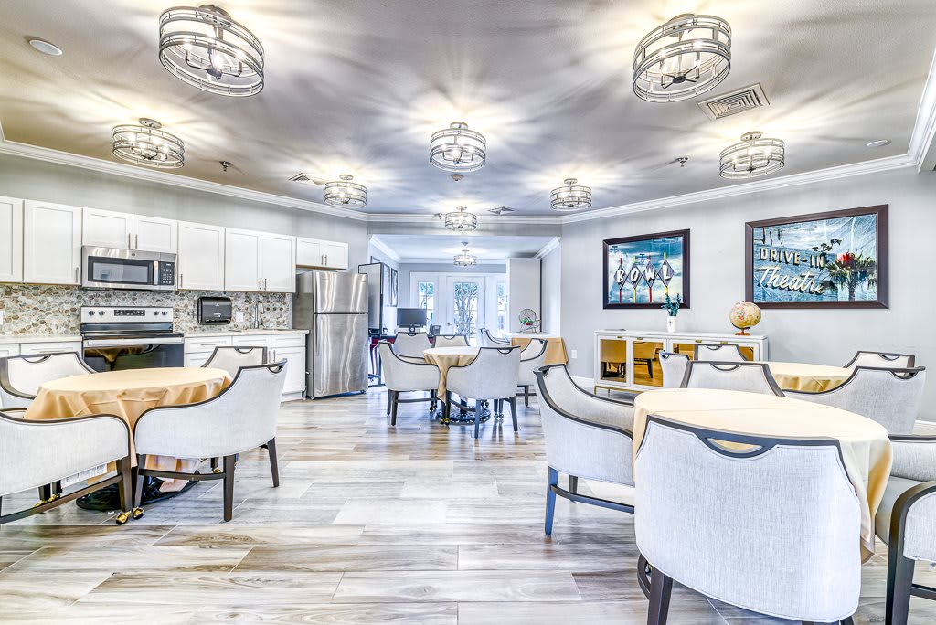 A modern and elegant dining area with bright lighting and a white color scheme.