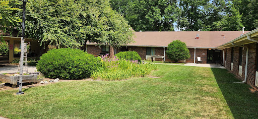 A charming home surrounded by lush greenery and well-kept gardens.
