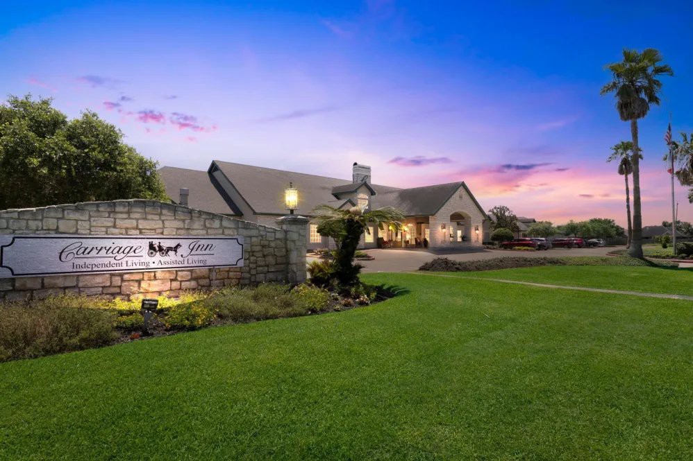 A beautiful house with a well-maintained yard during sunset.