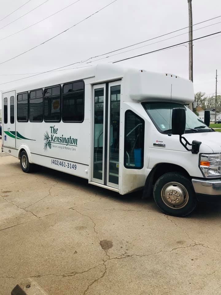 A white shuttle bus parked on the street.
