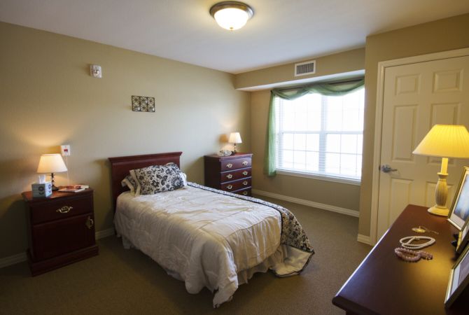A cozy bedroom with a single bed and wooden furniture.