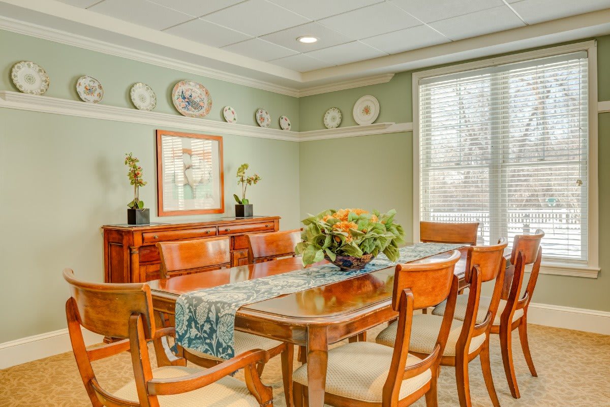 A well-decorated dining room featuring wooden furniture and decorative plates.