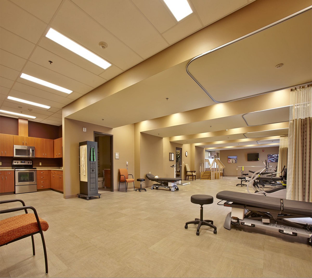 A modern physical therapy clinic with therapy beds and a spacious layout.