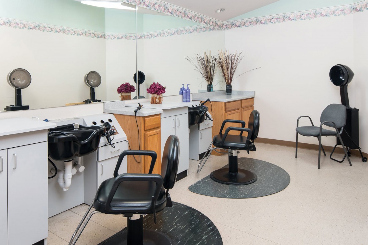 A clean and modern hair salon with styling chairs and mirrors.
