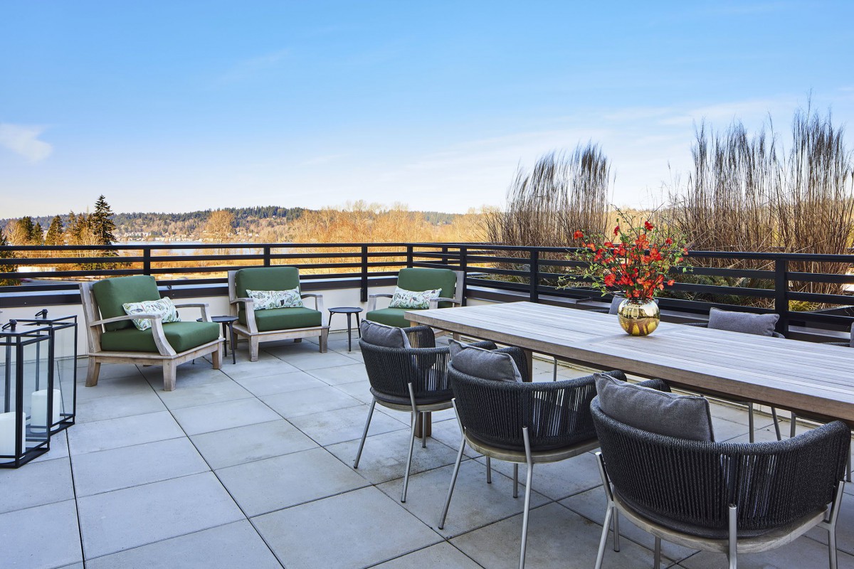 A spacious outdoor patio with comfortable seating and a scenic view.
