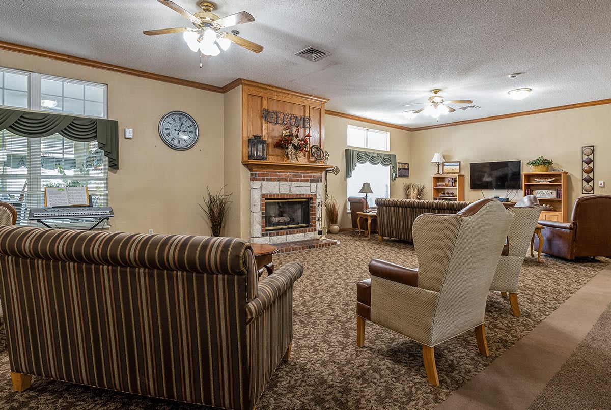 A cozy living room featuring a fireplace, comfortable seating, and warm decor.