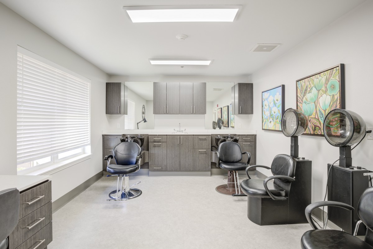 A modern hair salon with chairs, mirrors, and salon equipment.