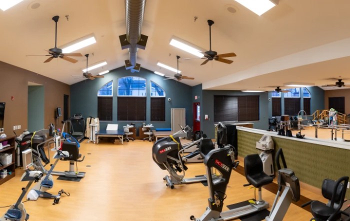 A well-equipped gym interior with various exercise machines and a spacious layout.