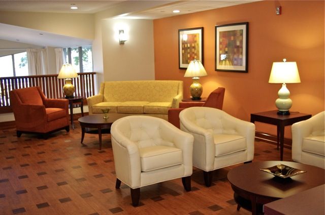 A cozy living room with comfortable seating and warm lighting.