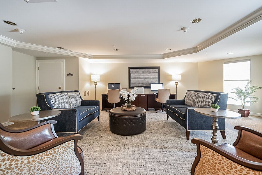 A cozy living room with sofas, chairs, and a computer desk.