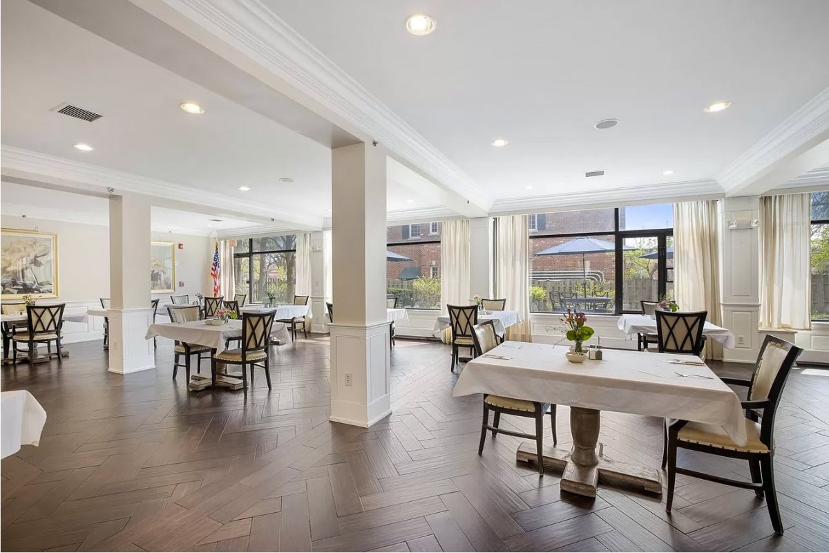 A spacious, well-lit dining area with modern decor and elegant furnishings.