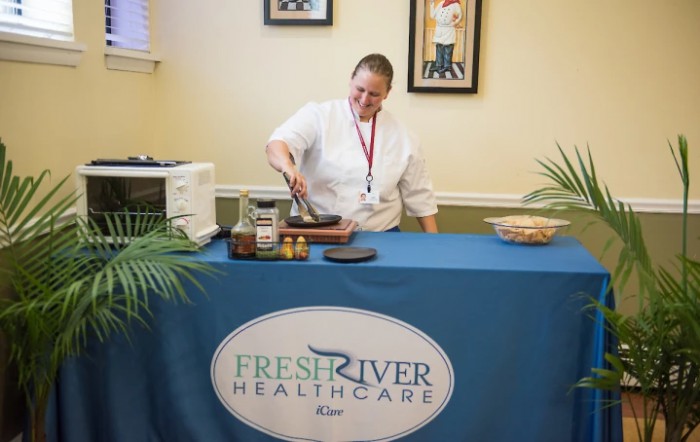 A chef conducting a cooking demonstration at a Fresh River Healthcare event.