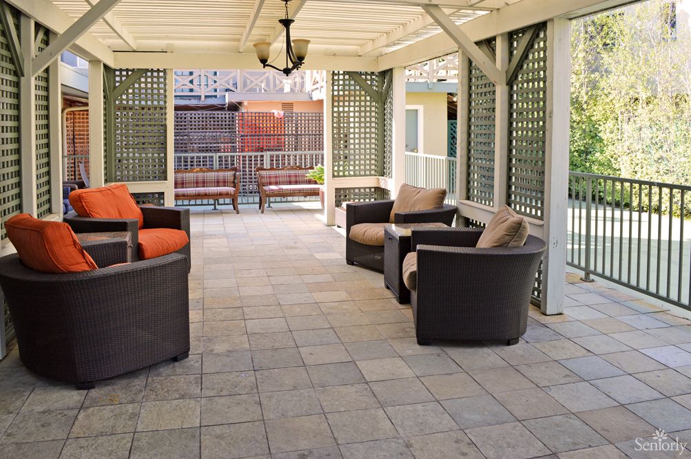 An inviting outdoor patio with comfortable seating under a covered structure.