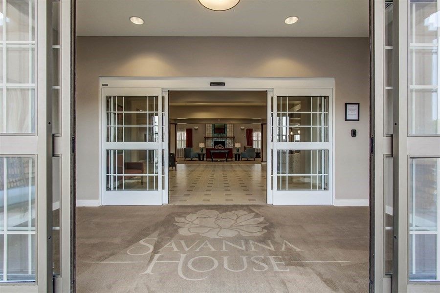 A view of a lobby entrance with open double doors leading into a spacious interior.