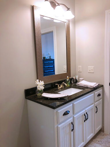 A modern bathroom vanity featuring a sleek mirror and elegant decor.