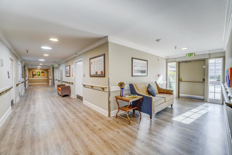 A bright and welcoming hallway with comfortable seating and tasteful decor.