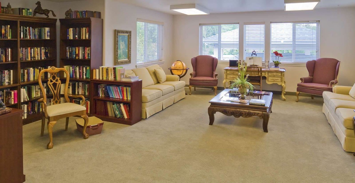 A cozy living room featuring a comfortable sofa, bookshelf, and a stylish coffee table.