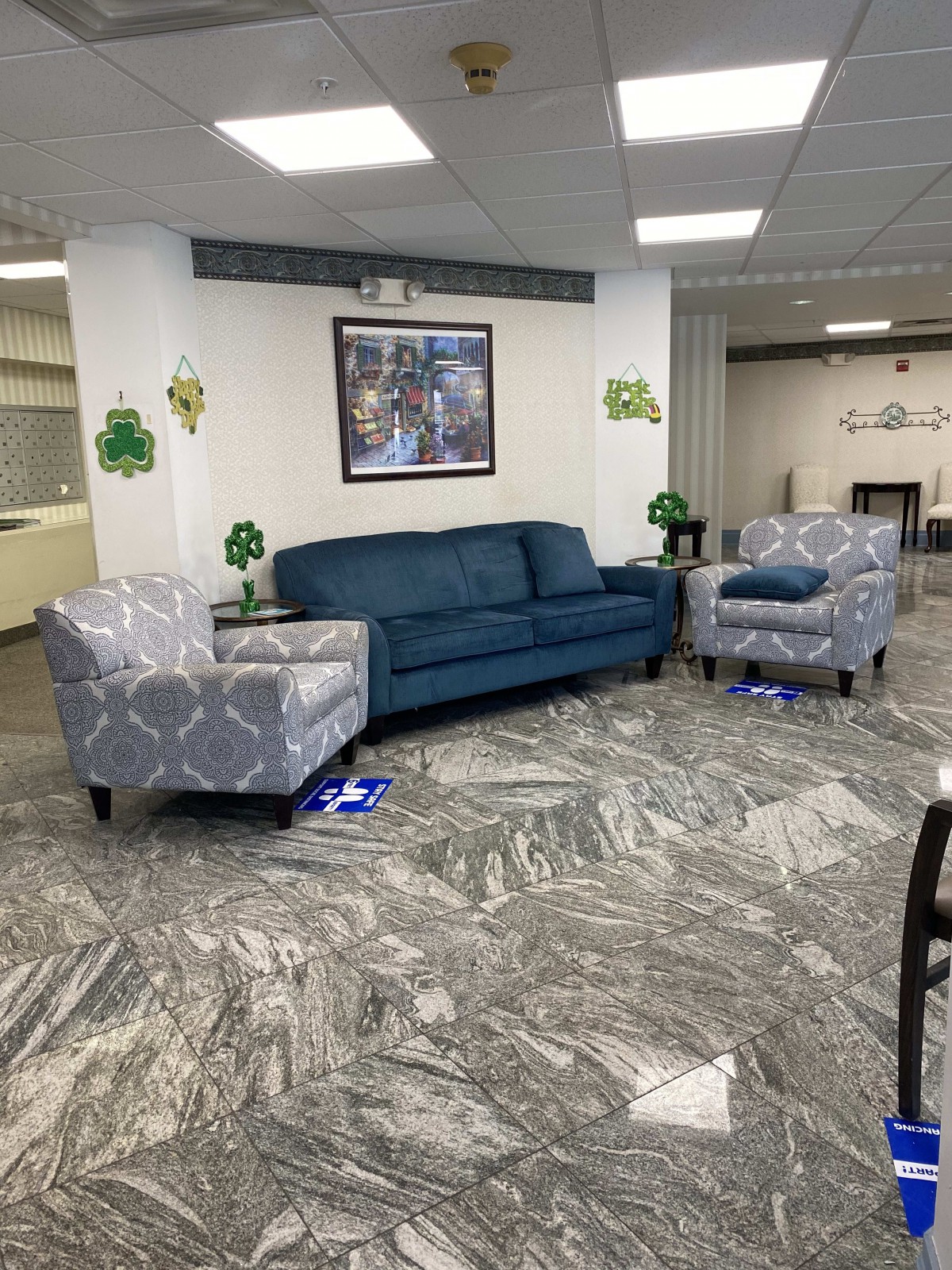 A cozy lobby area with blue and patterned seating, decorated with shamrocks.