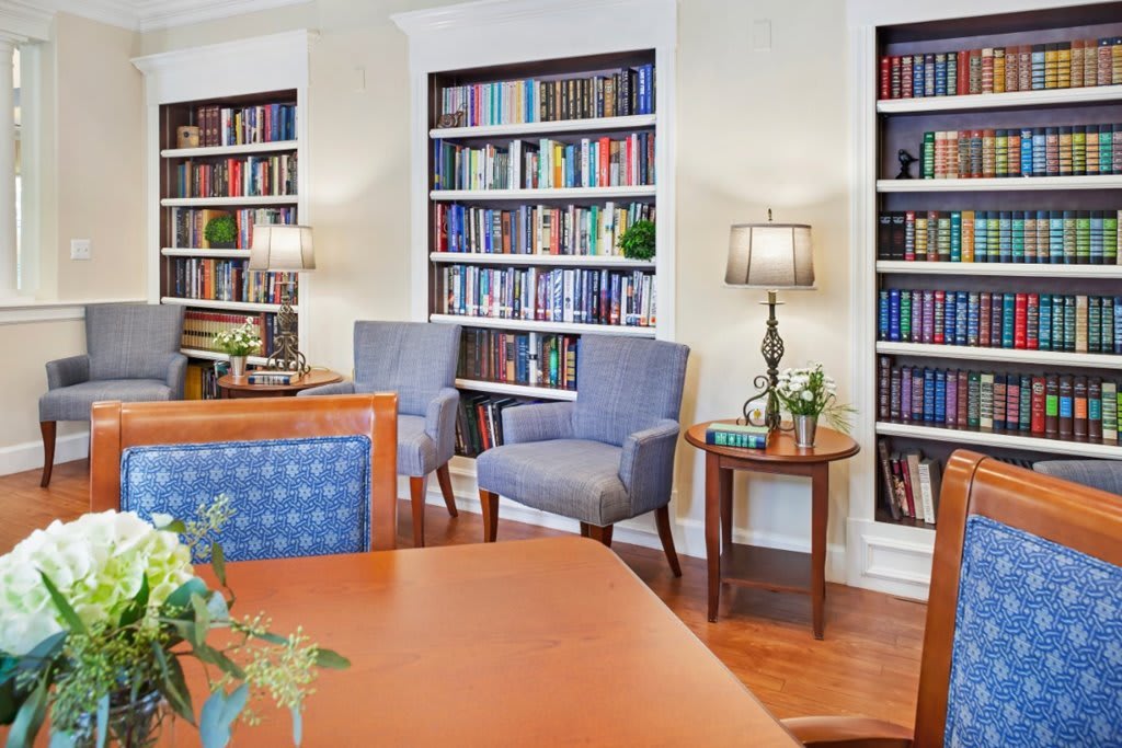 A cozy library with shelves filled with books, comfortable seating, and soft lighting for a perfect reading environment.